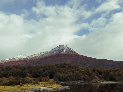 Free Scenic view of a snowcapped mountain surrounded by forest in Ushuaia, Argentina. Stock Photo