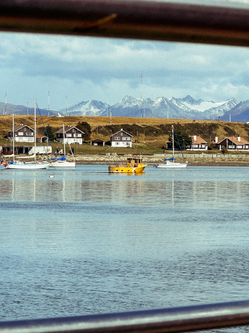 Free Peaceful scene of boats on water with Ushuaia's mountains in the background. Stock Photo