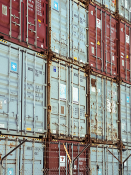 Vertical stack of colorful shipping containers at Ushuaia port, Argentina.