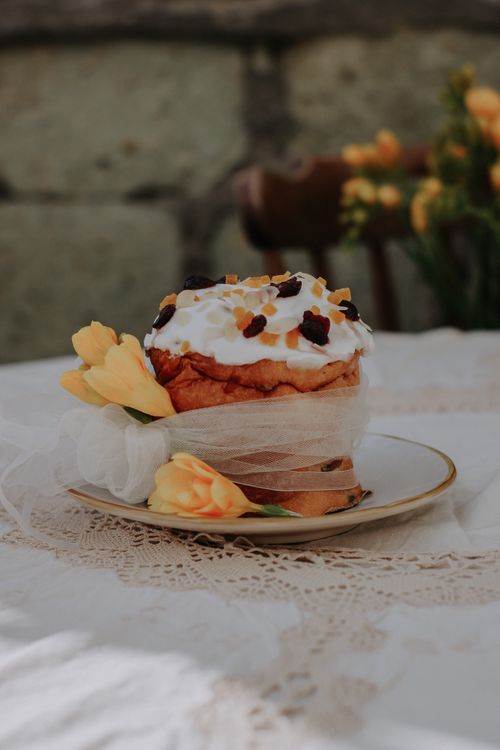 Free Easter cake beautifully decorated with icing and flowers on lace tablecloth. Stock Photo