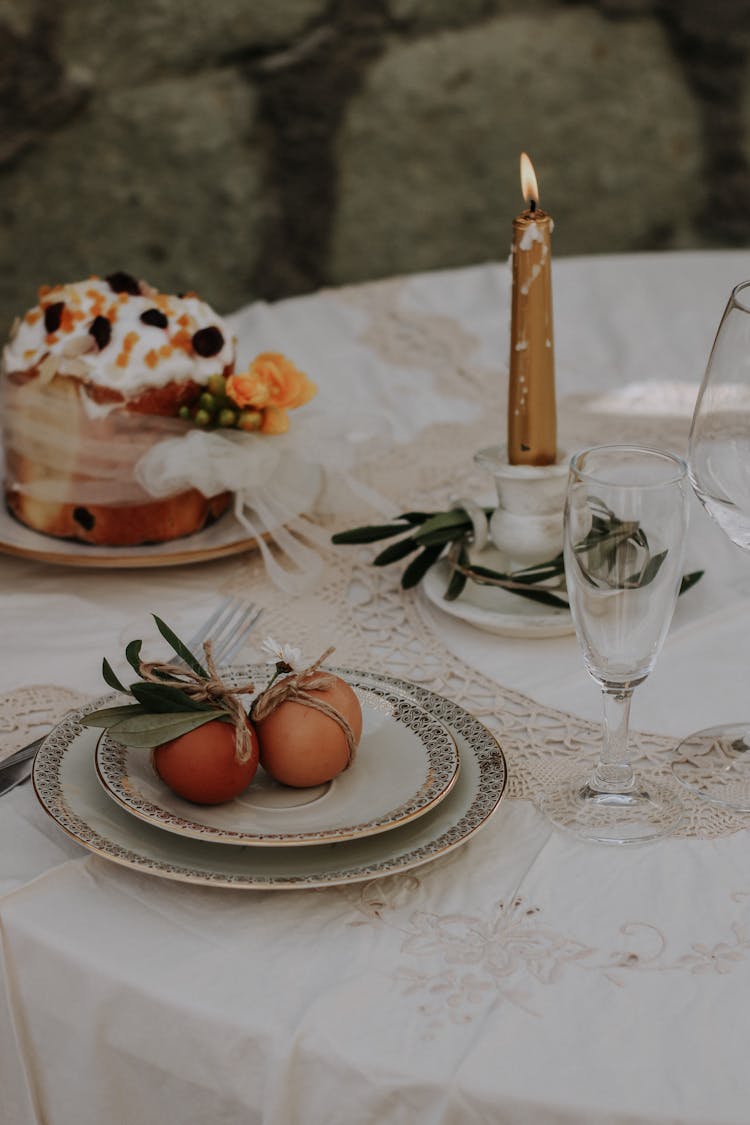 Candle On Table With Easter Dishes