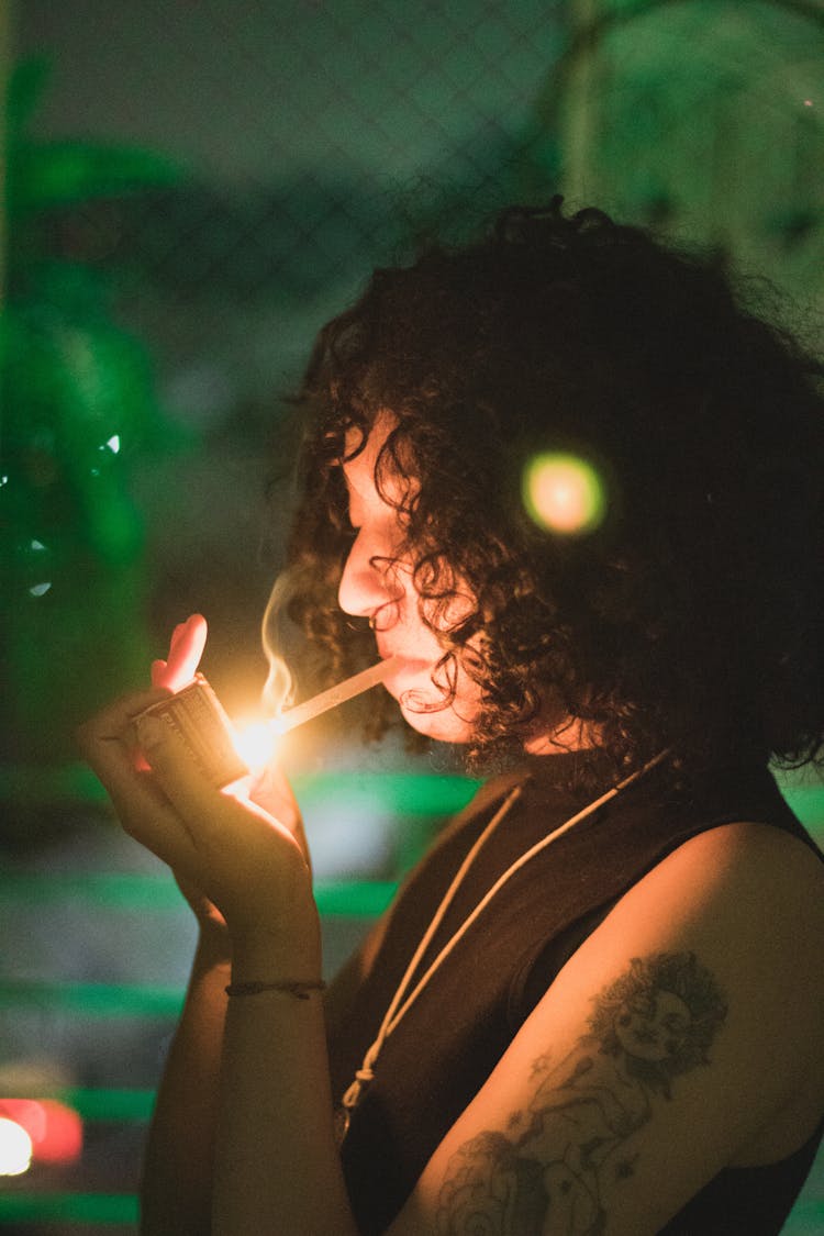 Woman Starting To Smoke Cigarette