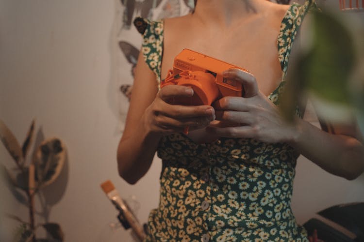 Close-up Of Woman Holding A Polaroid Camera 