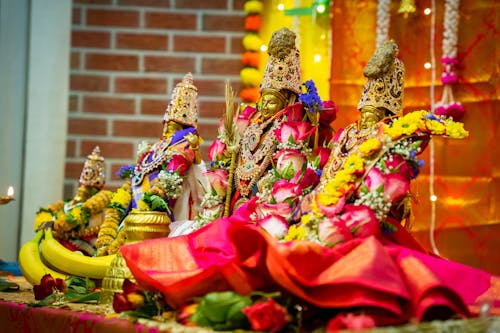 Hindu Deities Figurines Decorated with Colorful Flowers