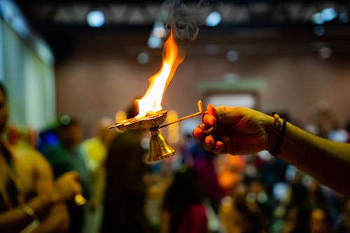 Hand Holding Burning Candlestick