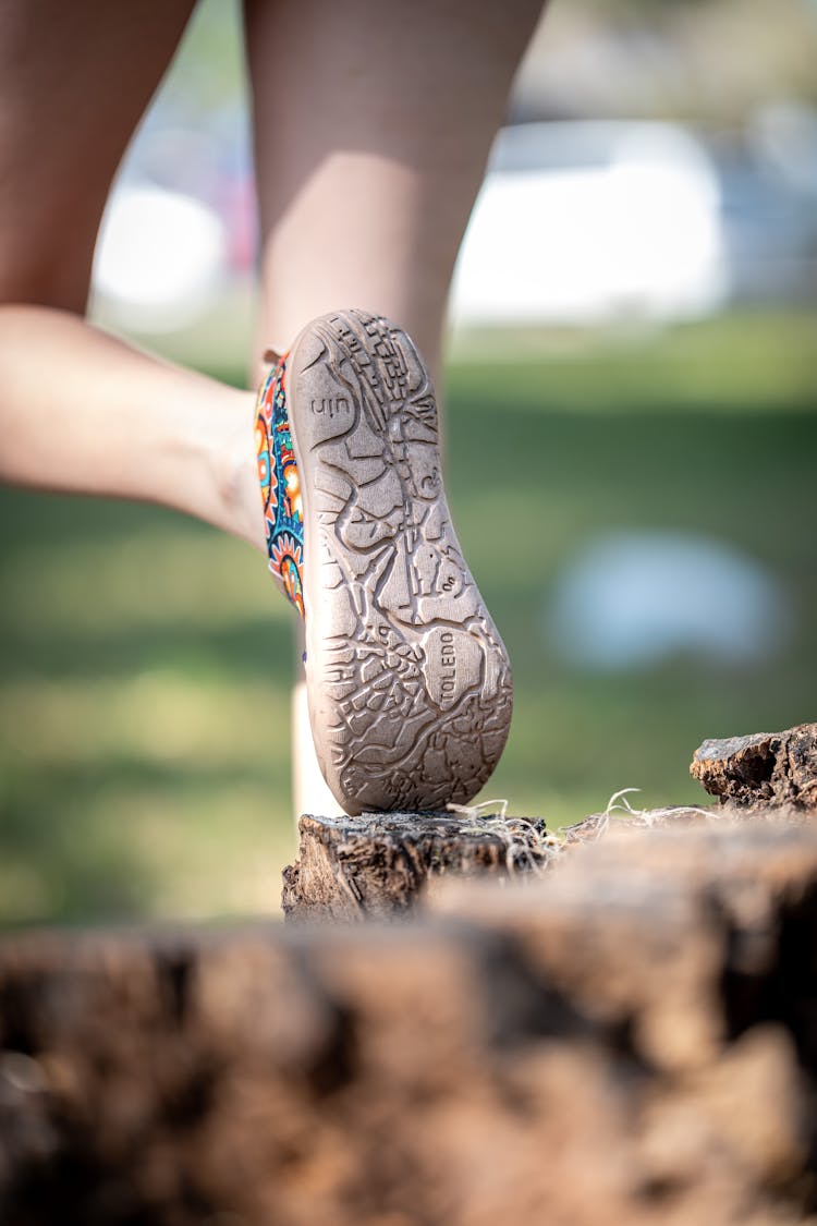 A Woman's Feet Are Shown In The Sand