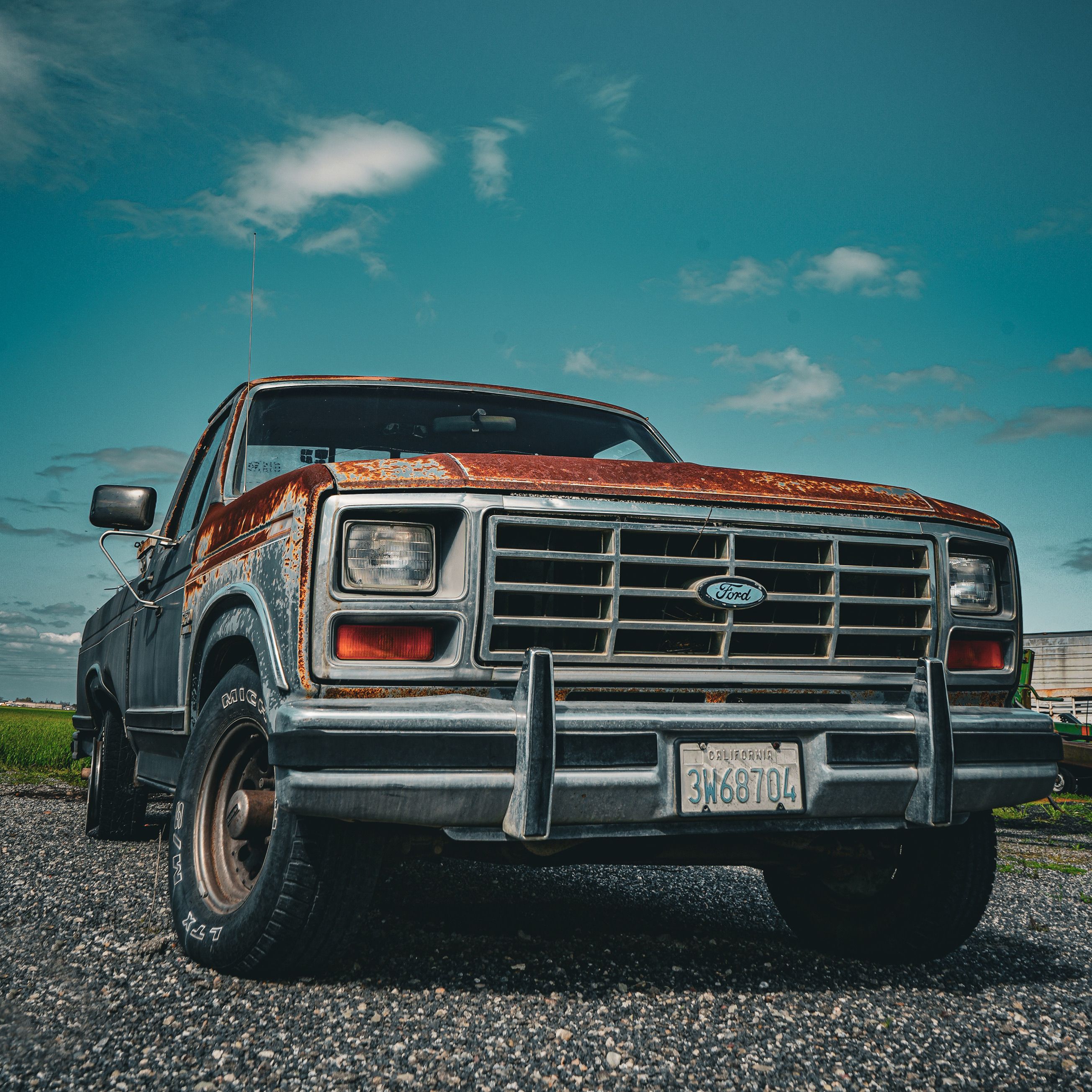 A classic rusty pickup truck parked outdoors showcasing its rugged charm.