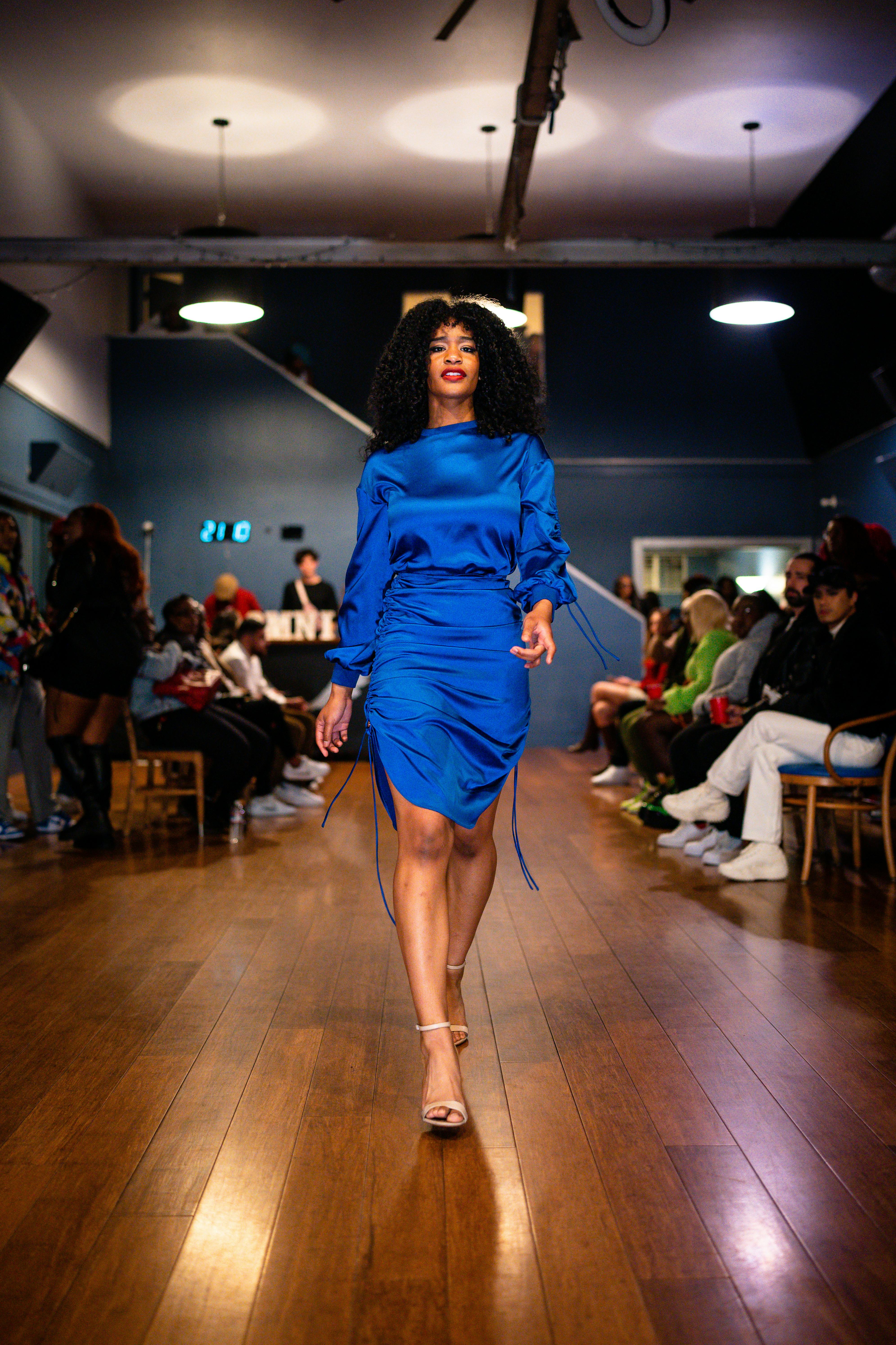 woman in a blue dress on a fashion show