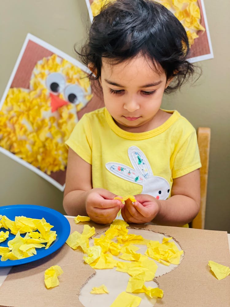 Girl Making Bird From Paper Straps