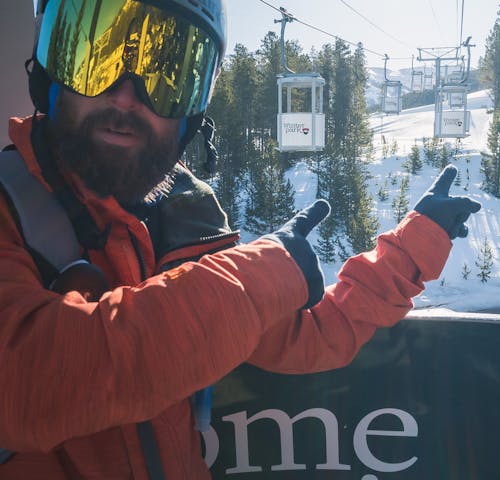 Man Pointing on Ski Lift