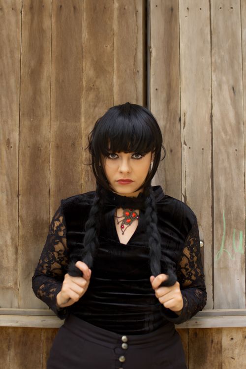 Free Stylish portrait of a woman with braids posing against a wooden background. Stock Photo