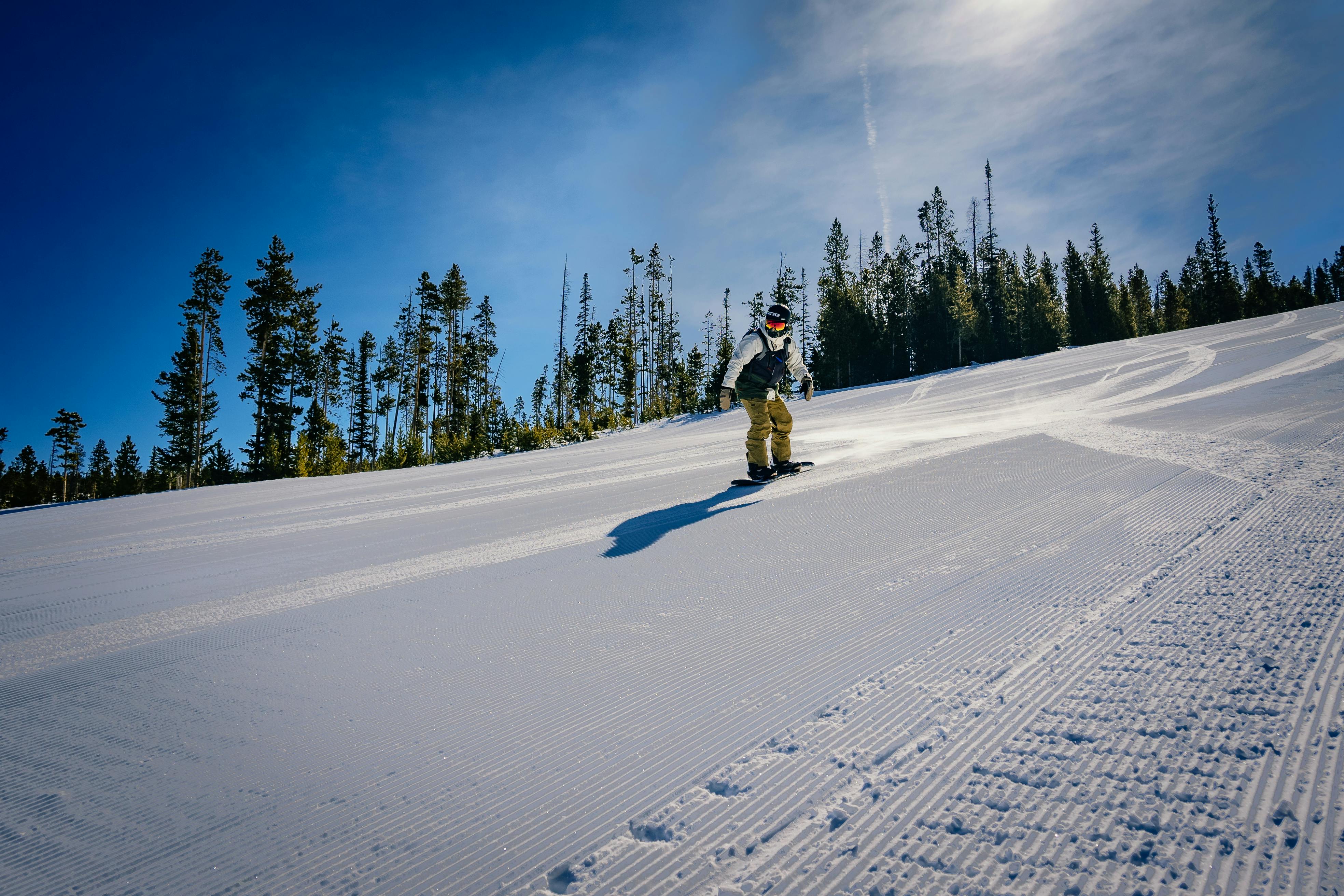 Prescription Goggle Inserts - A person snowboarding down a snowy slope