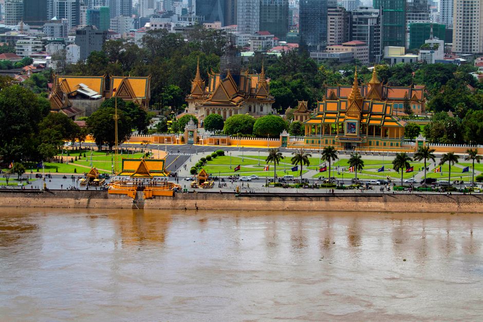 Stunning aerial perspective of Phnom Penh's Royal Palace with modern cityscape backdrop.