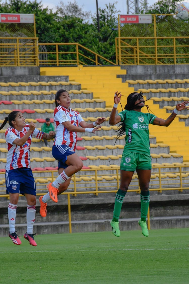 Women Playing Football On Stadium