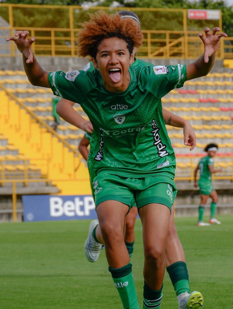 Woman Soccer Player Cheering During A Match 