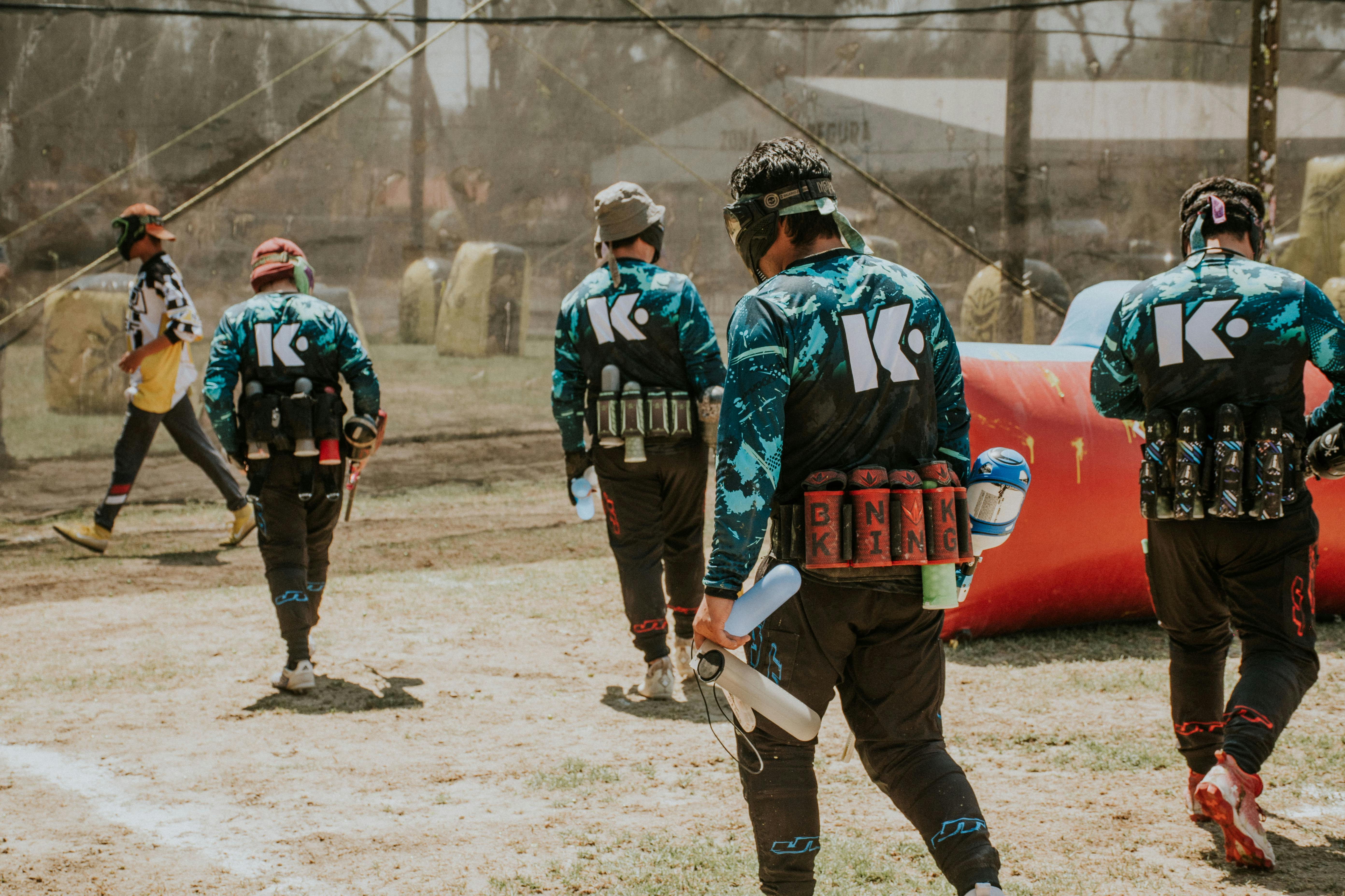 back view of men playing paintball