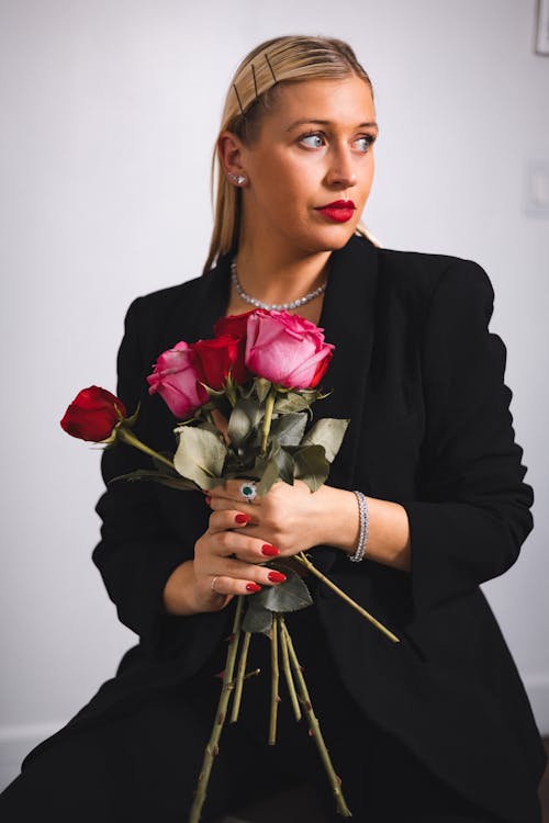 Model in a Black Blazer with a Bouquet of Red Roses