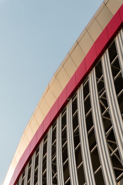 Free Creative view of a modern stadium's curved facade in Surakarta, Indonesia, showcasing bold lines and colors. Stock Photo