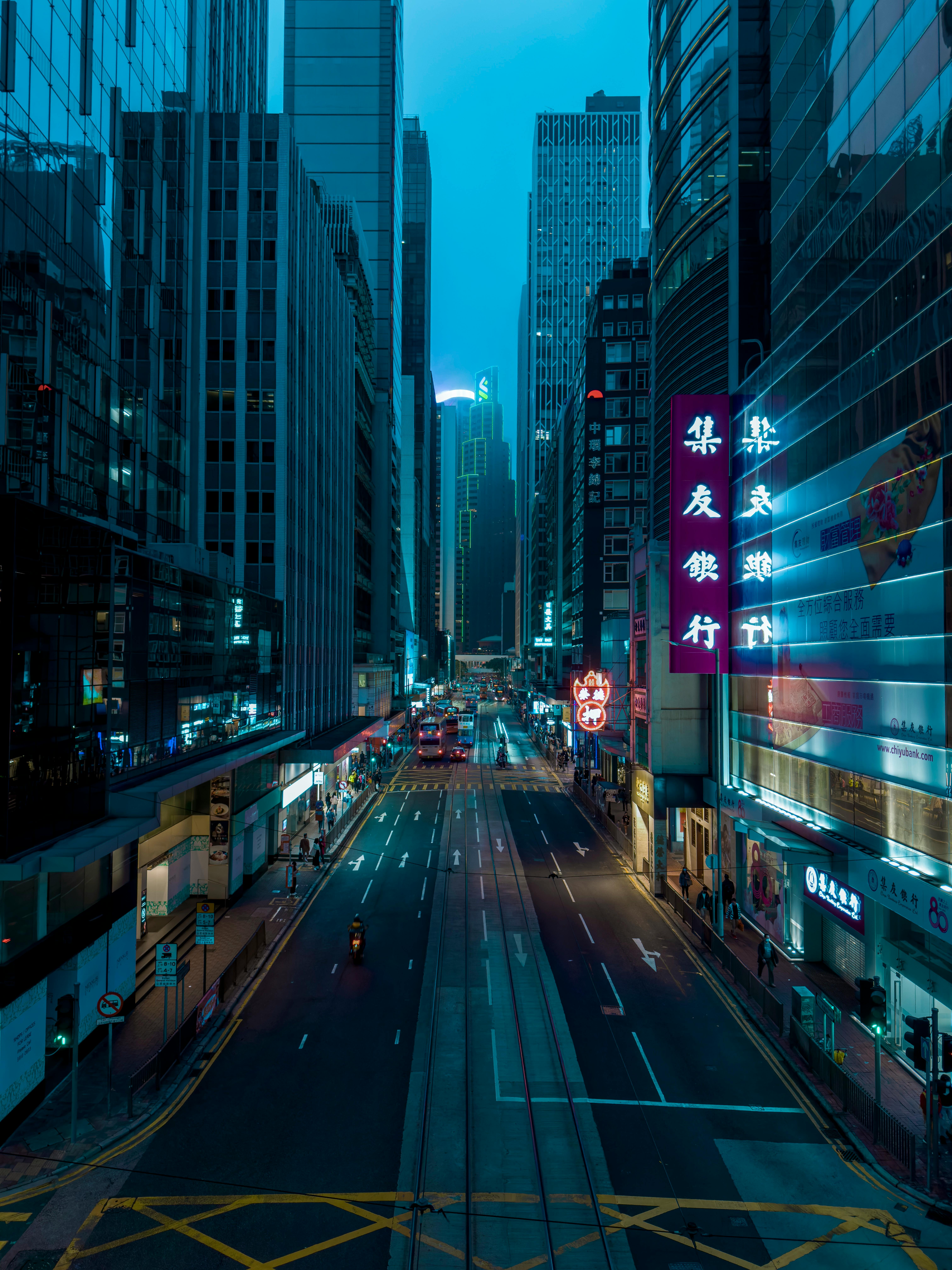 Dramatic twilight view of Hong Kong's bustling city streets and skyscrapers.