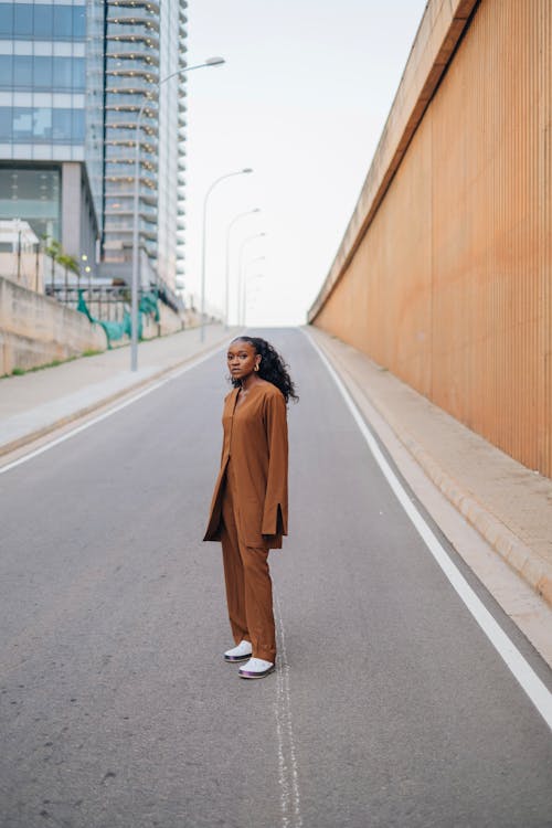 Model in a Brown Jacket and Pants Posing on the Street