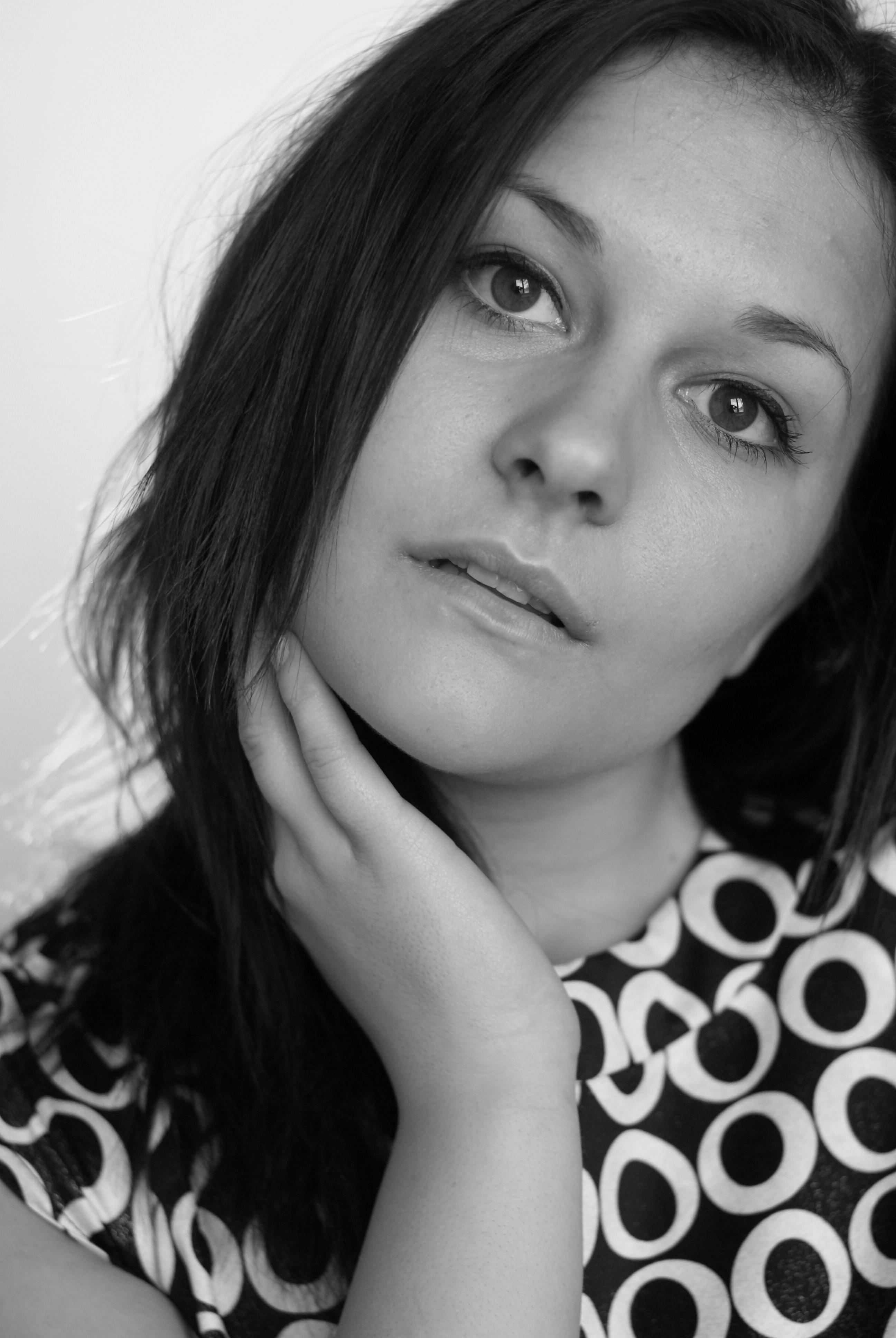 A woman with long hair posing for a black and white photo · Free Stock