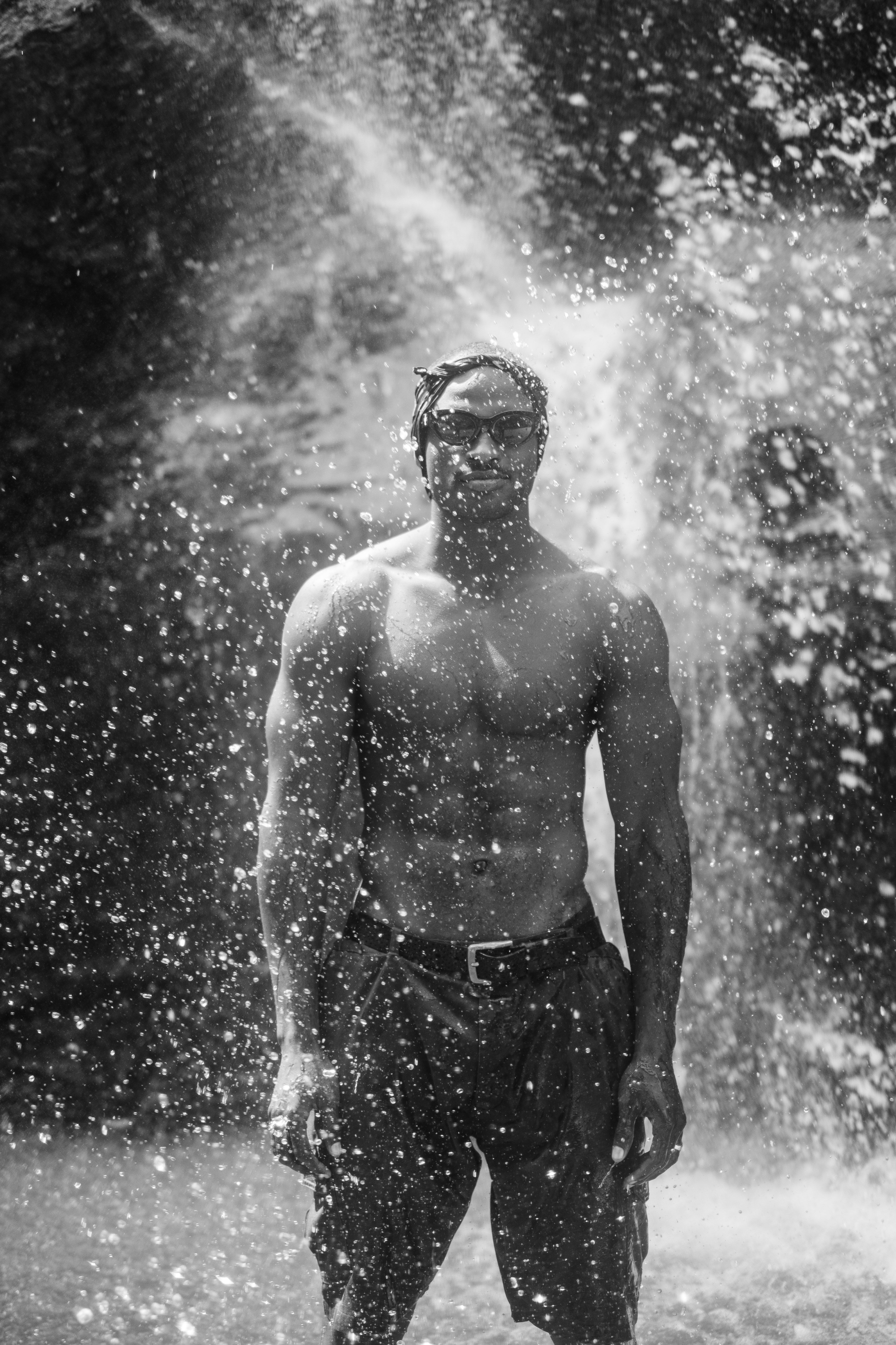 Free Muscular Shirtless Man Standing in Splashing Water  Stock Photo