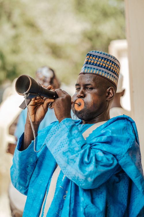 Free Portrait of a black man in Maiduguri, Nigeria, playing a traditional musical instrument outdoors. Stock Photo