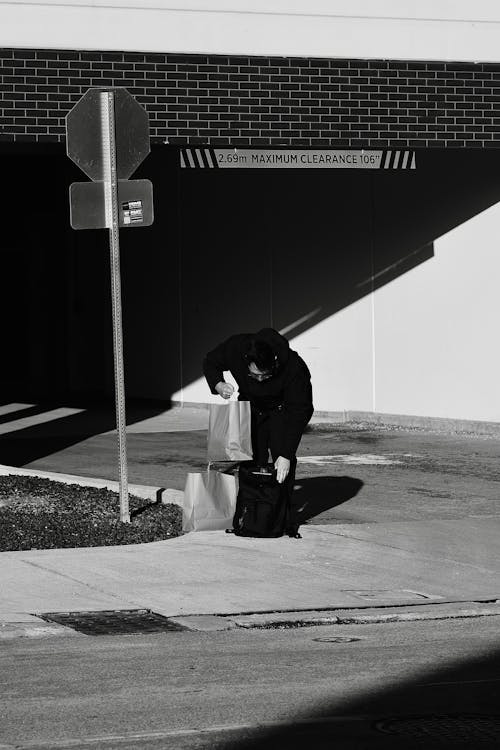 Candid Picture of a Man with Shopping Bags on the Sidewalk