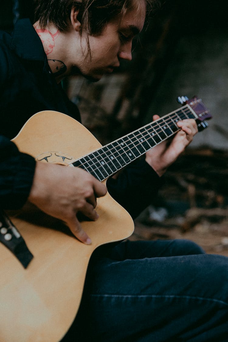 Musician Playing On Acoustic Guitar