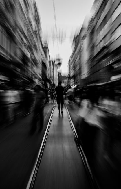Black and white cityscape with blurred motion capturing an urban street.