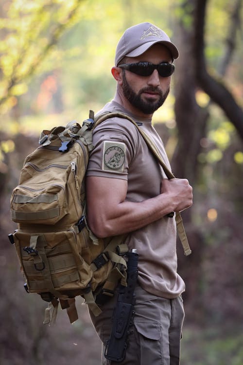 Free Man in Cap, Sunglasses and with Backpack Stock Photo