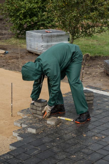 Paving specialist laying driveway blocks