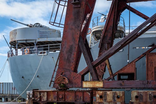 A Ship and Rusty Machinery in a Port 