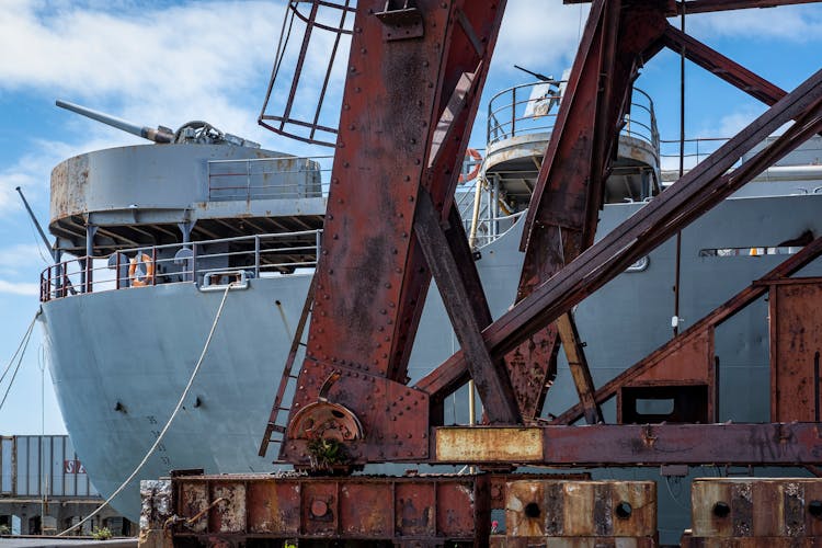 A Ship And Rusty Machinery In A Port 