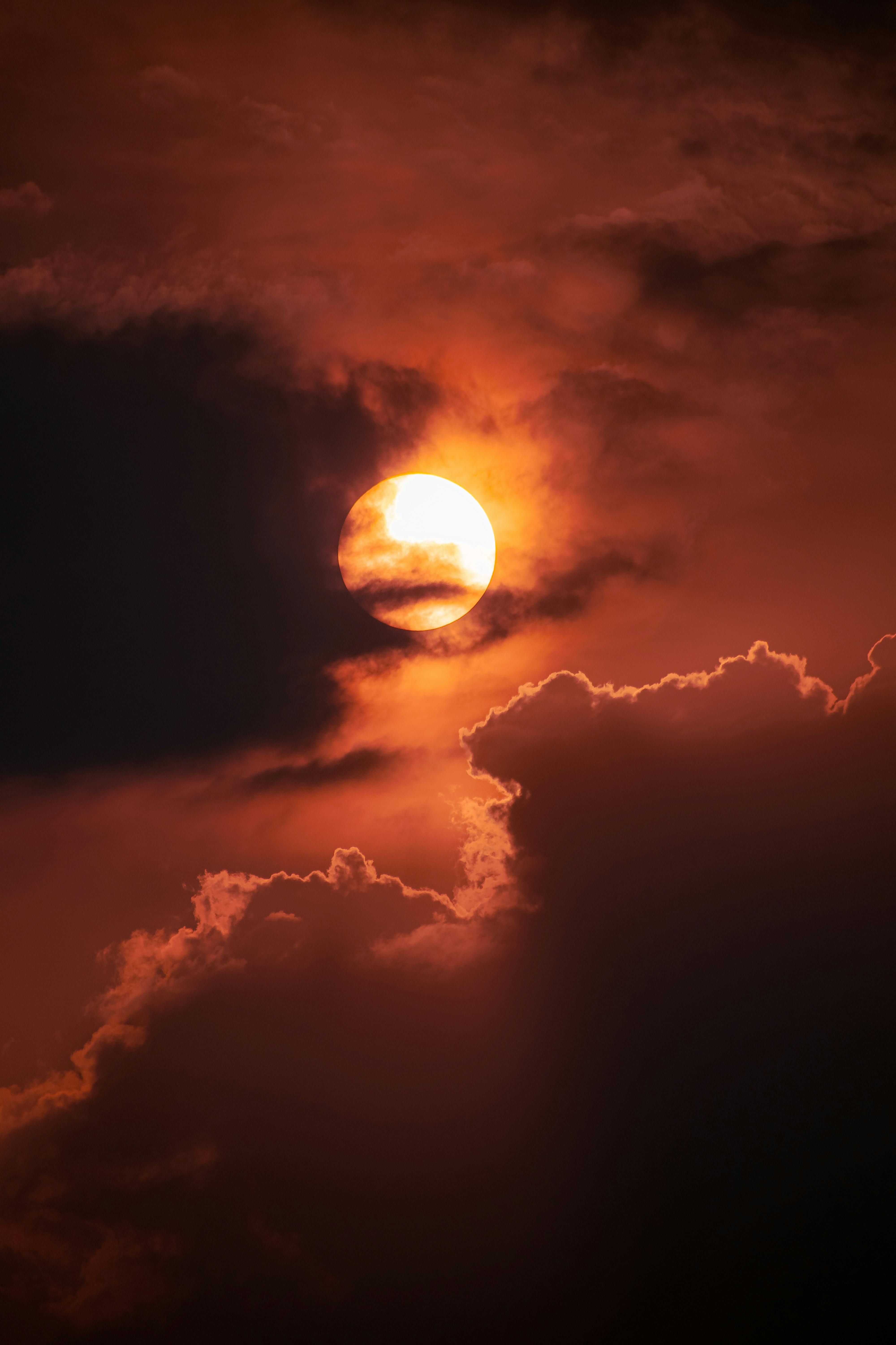 Sun on Red Sky behind Clouds at Dusk · Free Stock Photo