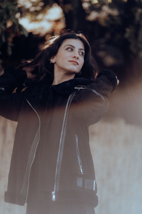 Free Fashionable woman in Fethiye outdoors wearing a black jacket, warm autumn vibe. Stock Photo