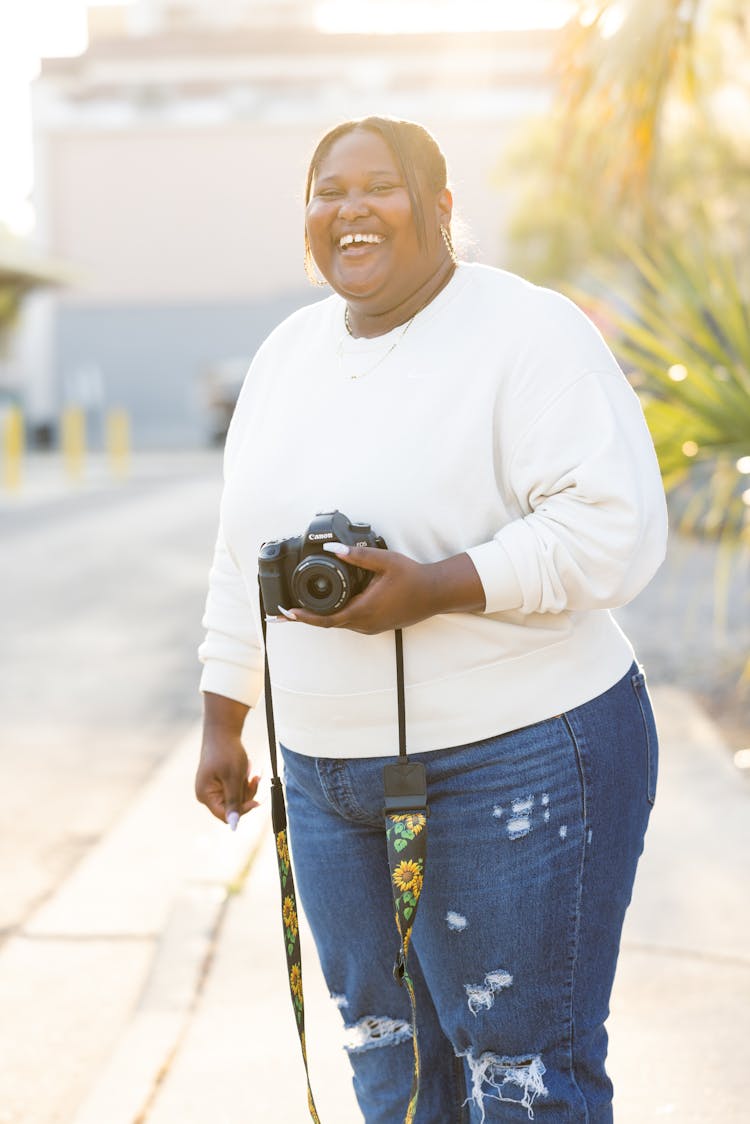 Smiling Overweight Woman With Camera Outdoors