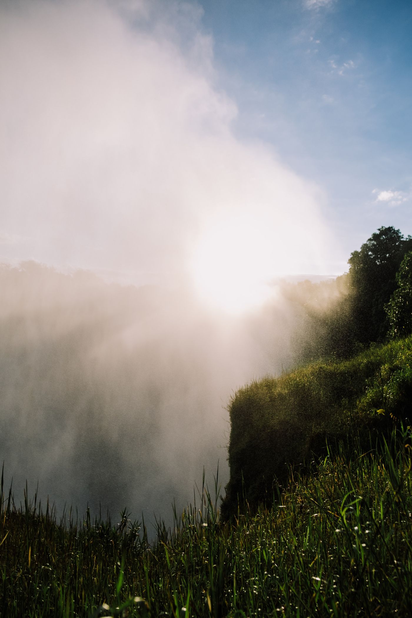 Waterfall and green landscape illuminated by soft morning light
