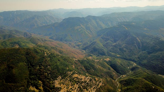 Scenic aerial view of verdant mountain ranges in Bulgaria captured during summer daylight. by Indigo  Blackwood