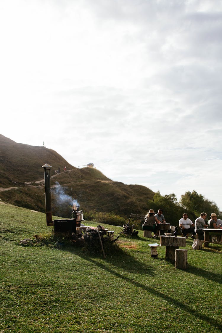 Sunlight Over People Sitting On Camping On Hill