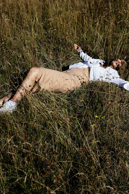 Woman in Skirt Lying Down on Sunlit Grass