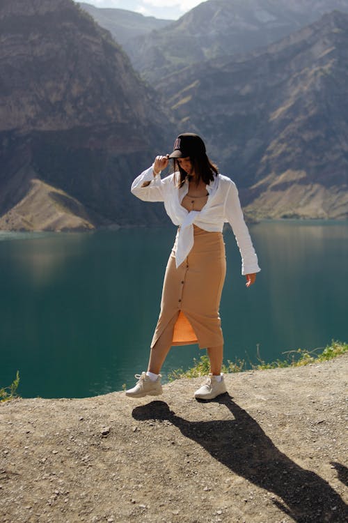 Woman in White Shirt Posing on Lakeshore