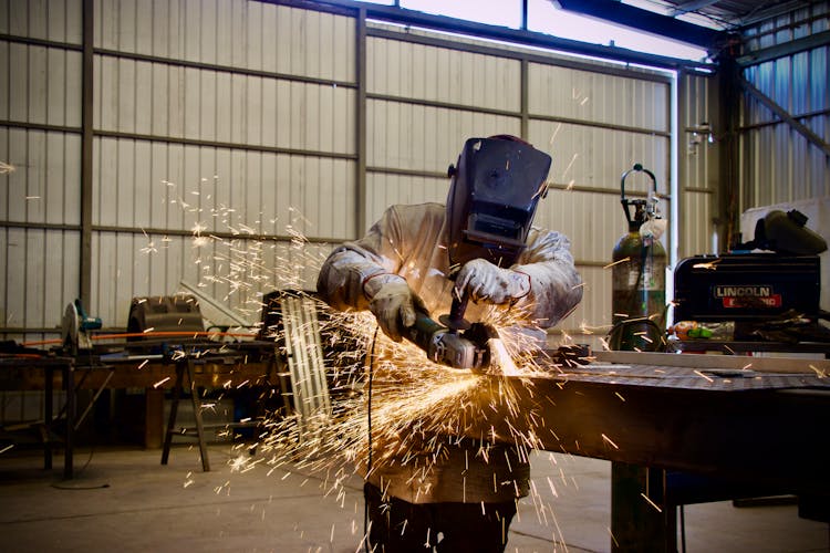 Welder Working At Workshop