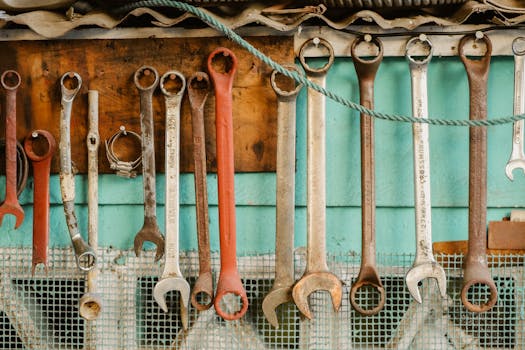 A collection of wrenches hanging neatly on a workshop wall displaying organization.