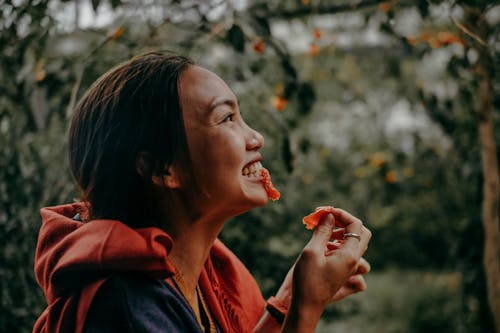 Free Woman Biting Red Fruit Stock Photo