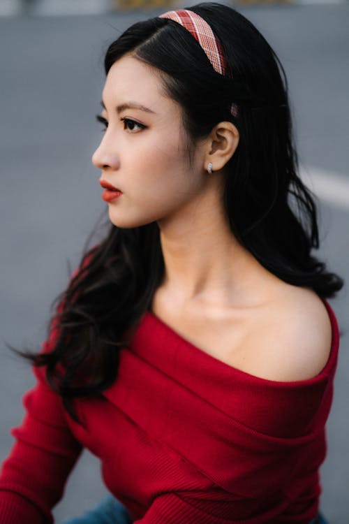 Young Brunette Wearing a Red Off Shoulder Top 