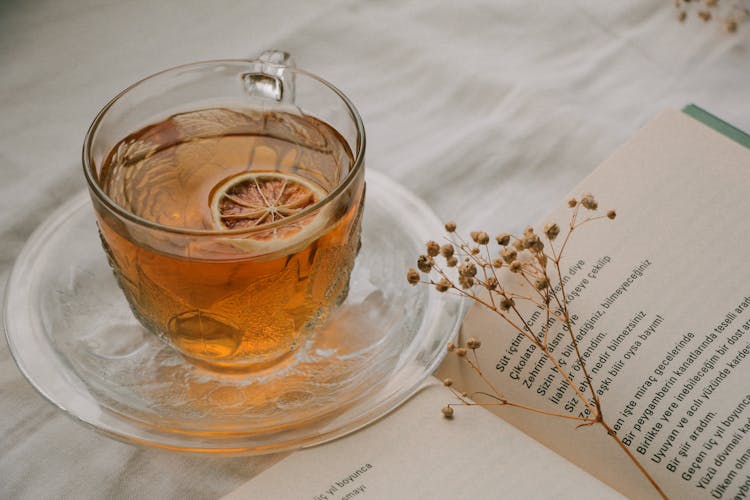 Tea And Open Book On Table