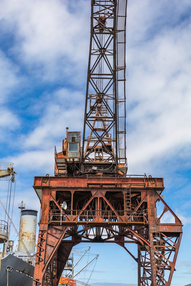 A Rusty Crane In A Port 