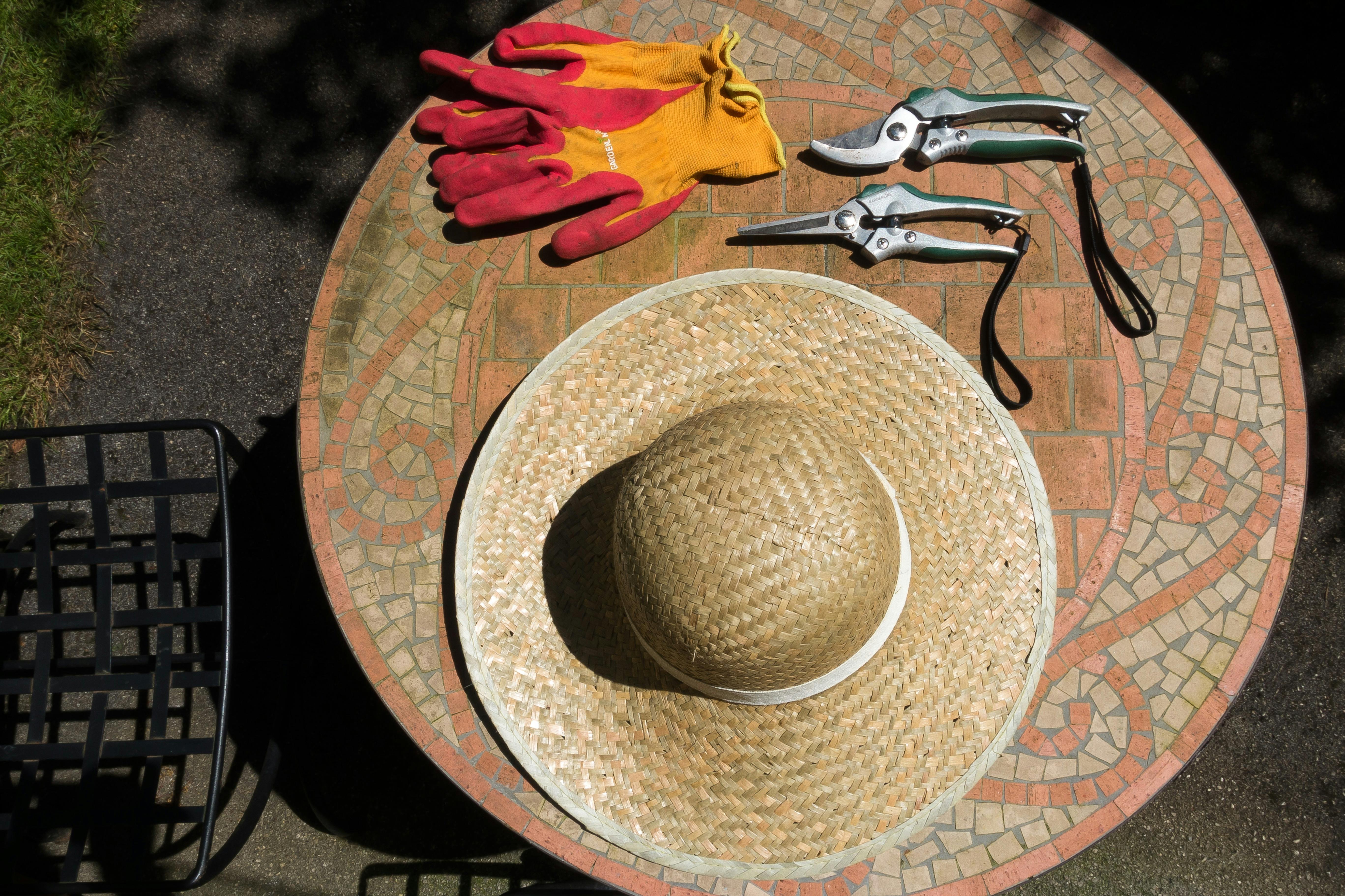 Brown Woven Hat over Brown Wooden Round Table Top