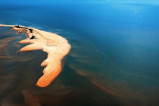 Stunning aerial view of a sandy peninsula jutting into the ocean near Chukai, Malaysia.